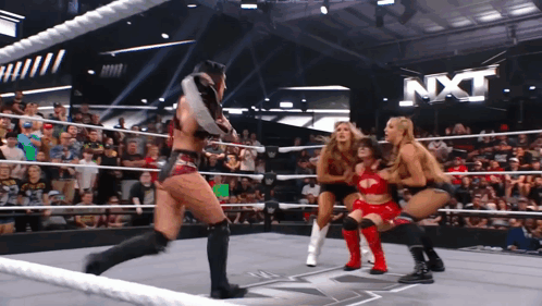 A Group Of Women Are Wrestling In A Ring With Nxt Written In The Background GIF