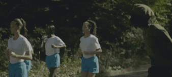 A Group Of Women In Blue Shorts Are Running On A Road GIF