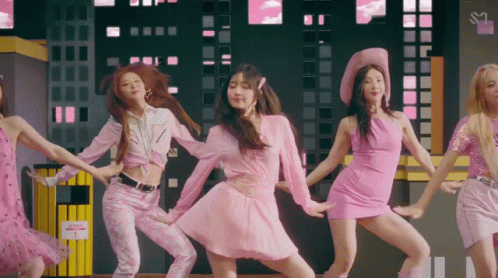 A Group Of Women In Pink Dresses Are Dancing Together GIF