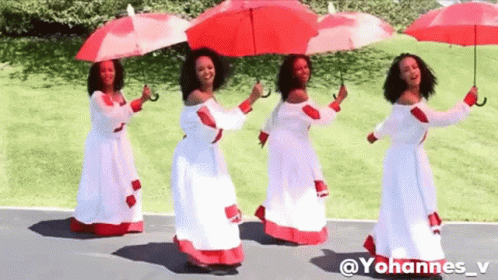 A Group Of Women In White Dresses Holding Red Umbrellas . GIF