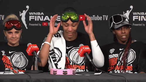 A Group Of Women Sitting At A Table Wearing Shirts That Say Wnba GIF