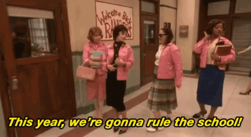 A Group Of Women Standing In A Hallway With The Words " This Year We 'Re Gonna Rule The School " In Yellow Letters GIF