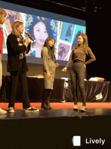 A Group Of Women Standing On A Stage With The Word Lively On The Bottom Right GIF