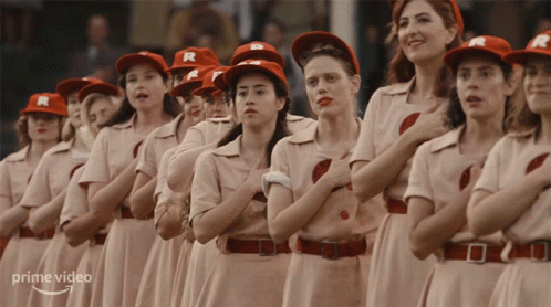 A Group Of Women Wearing R Hats Stand In A Line GIF