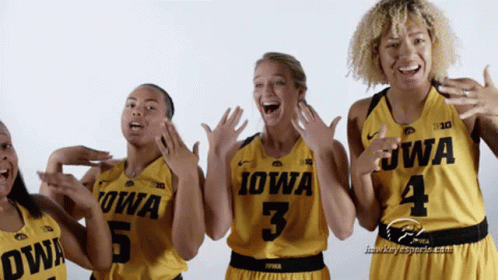 A Group Of Women Wearing Yellow Iowa Jerseys GIF