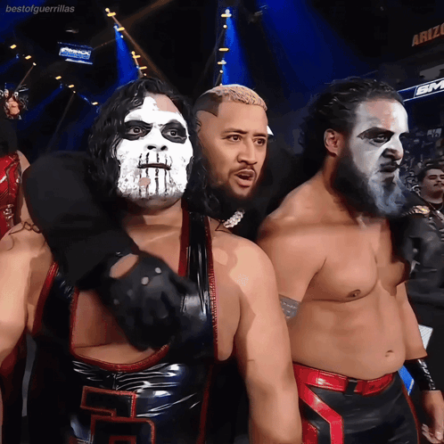 A Group Of Wrestlers Are Posing For A Picture In Front Of A Sign That Says Bestofguerrillas GIF