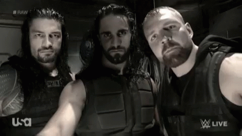 A Group Of Wrestlers Are Posing For A Picture In Front Of A U-S-A Logo GIF