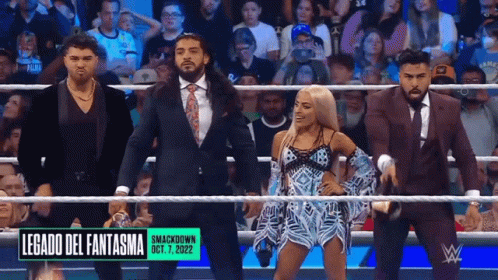 A Group Of Wrestlers Are Standing In A Ring With A Sign That Says Legado Del Fantasma On It GIF