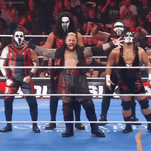 A Group Of Wrestlers Are Standing In A Ring With The Word Bestal Guerrillas On The Bottom Right GIF
