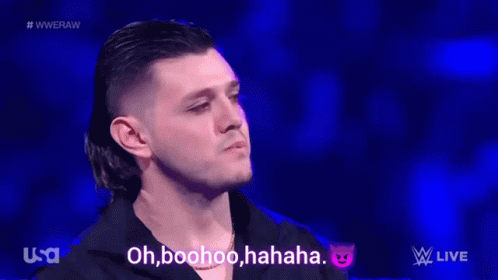 A Group Of Wrestlers Are Standing In A Wrestling Ring And One Of Them Says Oh Boohoo Haha GIF