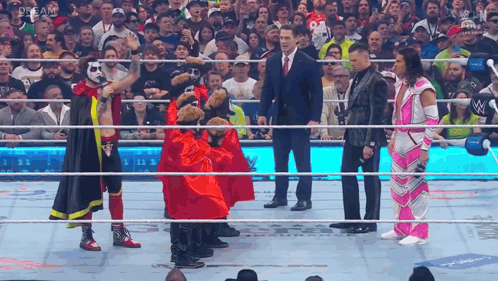 A Group Of Wrestlers Standing In A Ring With The Word Dream On The Bottom Right GIF