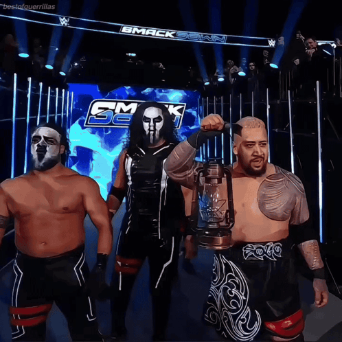A Group Of Wrestlers Standing In Front Of A Sign That Says Smack Down GIF