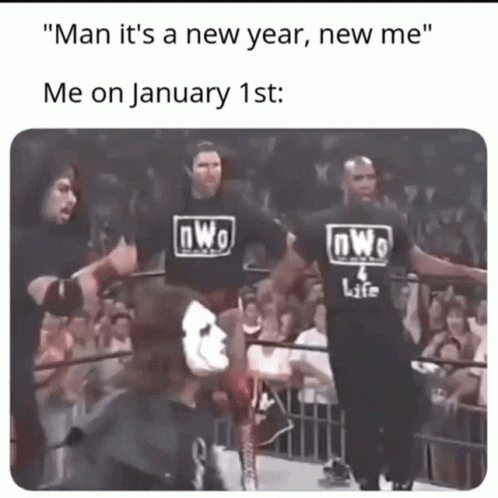 A Group Of Wrestlers Wearing Nwo Shirts Are Standing In A Wrestling Ring GIF