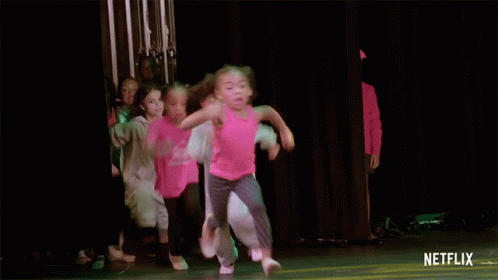 A Group Of Young Girls Are Dancing On A Stage With A Netflix Logo On The Bottom GIF