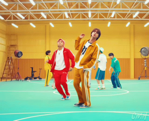 A Group Of Young Men Are Dancing In A Gym And One Of Them Has The Number 21 On His Jacket GIF
