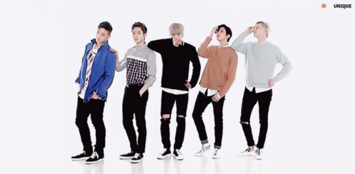 A Group Of Young Men Are Dancing In A Line With Their Arms Outstretched . GIF