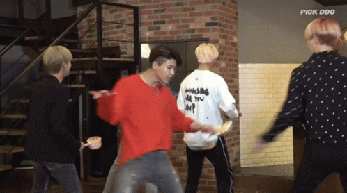 A Group Of Young Men Are Dancing In Front Of A Brick Wall And The Words Pick Doo Are On The Bottom GIF