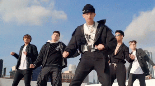 A Group Of Young Men Are Dancing On A Rooftop In Front Of A City Skyline GIF