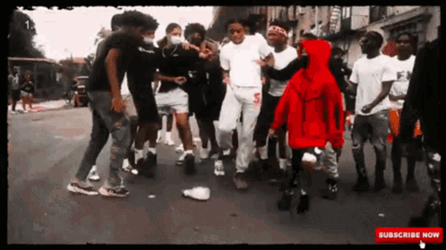 A Group Of Young Men Are Dancing On A Street With A Subscribe Now Button On The Bottom GIF