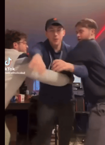 A Group Of Young Men Are Fighting In A Room With Tiktok Written On The Bottom Right GIF
