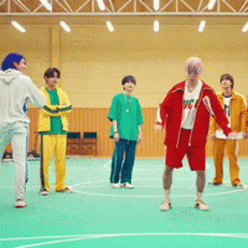 A Group Of Young Men Are Playing Basketball In A Gym And One Of Them Is Wearing A Shirt That Says Mc GIF