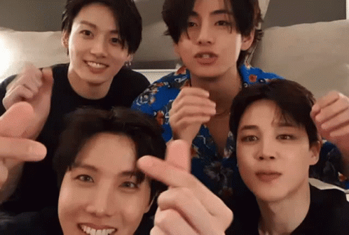 A Group Of Young Men Are Posing For A Picture And Making Heart Shapes With Their Fingers . GIF