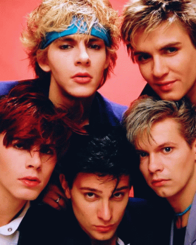 A Group Of Young Men Are Posing For A Picture And One Has A Blue Headband On GIF