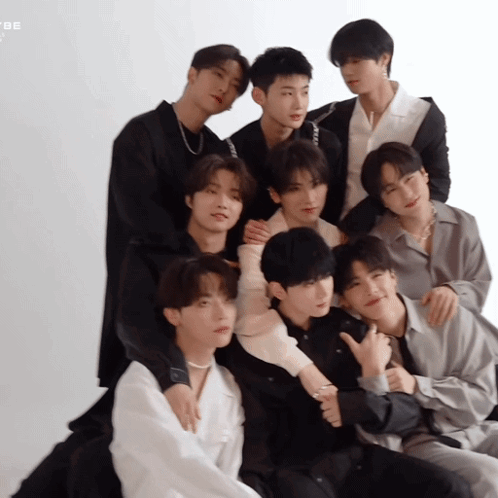A Group Of Young Men Are Posing For A Picture And One Of Them Is Giving The Thumbs Up Sign GIF