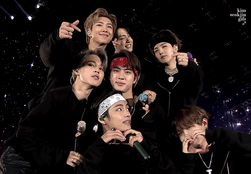A Group Of Young Men Are Posing For A Picture And One Of Them Is Wearing A Bandana GIF