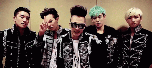 a group of young men are posing for a picture and one of them is wearing sunglasses