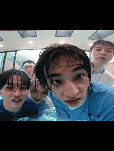 A Group Of Young Men Are Posing For A Picture In The Water GIF