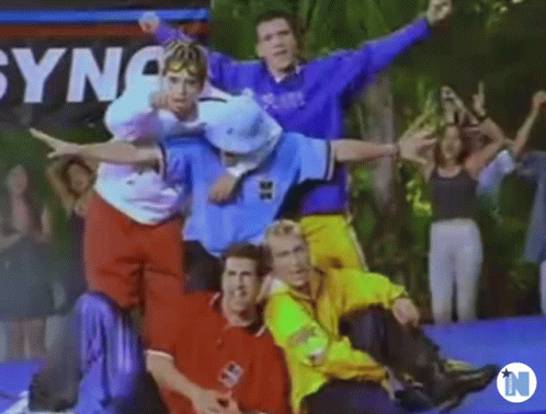 A Group Of Young Men Are Posing For A Picture While Sitting On A Trampoline . GIF
