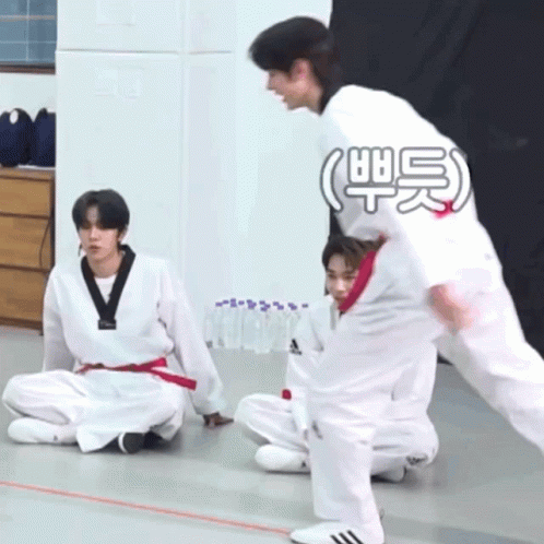 A Group Of Young Men Are Practicing Martial Arts And One Of Them Is Wearing A White Adidas Shirt GIF