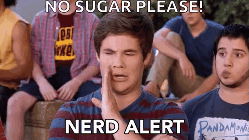 A Group Of Young Men Are Sitting Around A Table And One Of Them Is Wearing A Pandamovie Shirt GIF