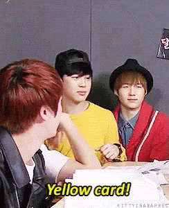 A Group Of Young Men Are Sitting At A Table And One Of Them Says Yellow Card GIF