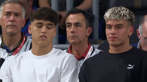 A Group Of Young Men Are Sitting In A Stadium And One Of Them Is Wearing A Puma Sweatshirt GIF