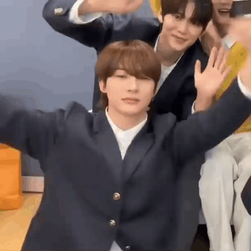 Young Men Sitting And Waving GIF