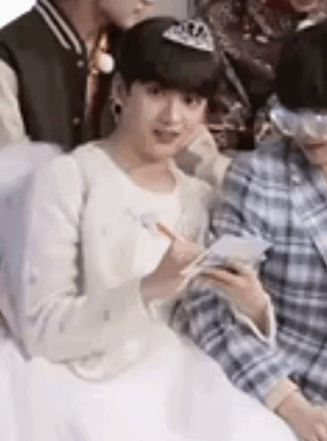 A Group Of Young Men Are Sitting Next To Each Other . GIF