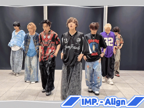 A Group Of Young Men Are Standing In Front Of A Wall With The Words Imp-Align On The Bottom Right GIF