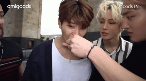 A Group Of Young Men Are Standing Next To Each Other And One Of Them Is Touching Another Man 'S Nose GIF