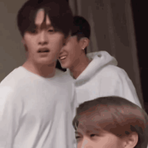 Group Of Men Standing, One In White Hoodie GIF