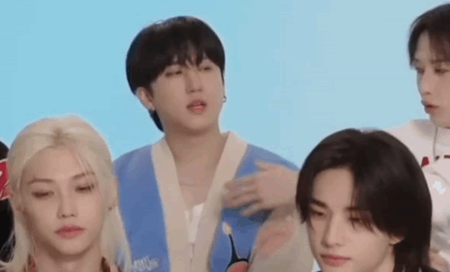 A Group Of Young Men Are Standing Next To Each Other And Talking . GIF