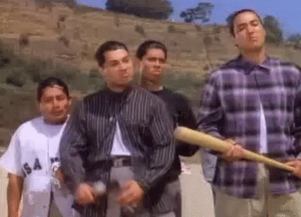 A Group Of Young Men Are Standing Next To Each Other Holding Baseball Bats And Guns . GIF