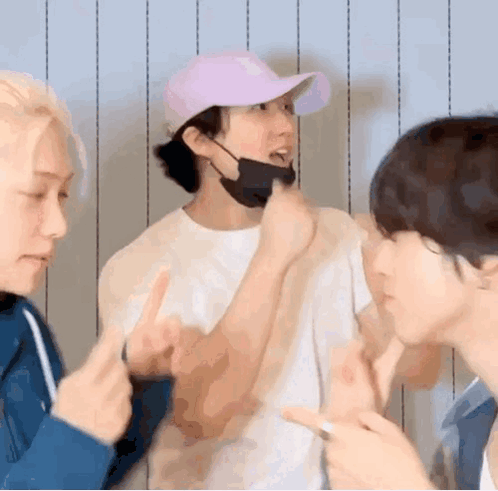 A Group Of Young Men Are Standing Next To Each Other Making Funny Faces . GIF
