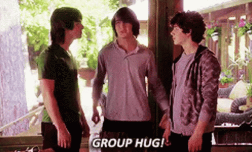 A Group Of Young Men Standing Next To Each Other In A Room . GIF
