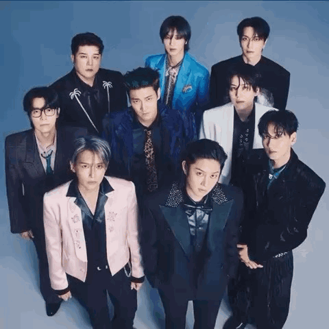 A Group Of Young Men Standing Next To Each Other In Suits And Ties . GIF