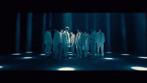 A Group Of Young Men Standing Next To Each Other Wearing White GIF