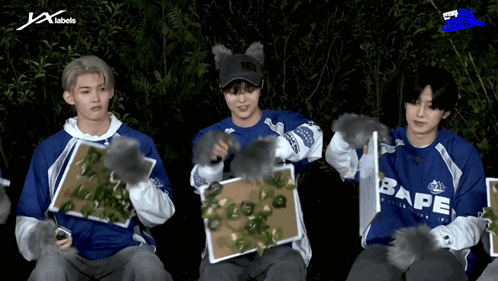 A Group Of Young Men Wearing Blue Shirts With Bape Written On Them GIF