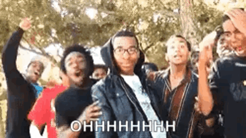 A Group Of Young People Are Dancing Together And One Of Them Is Wearing Glasses And A Hoodie . GIF