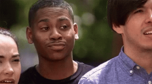 A Group Of Young People Are Standing Next To Each Other . GIF